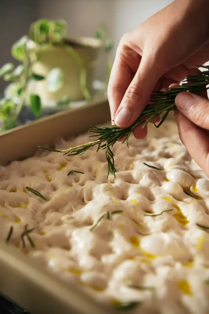 Focaccia dough being shaped and topped during JWC Academy baking practice