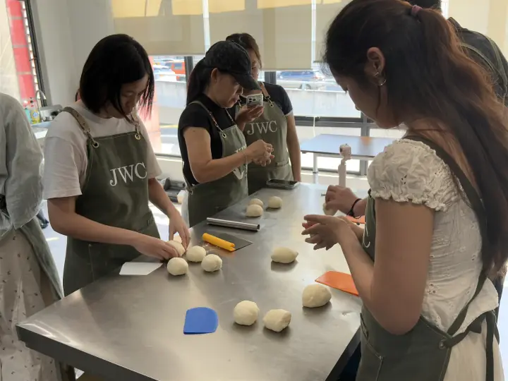 Students learning dough handling together