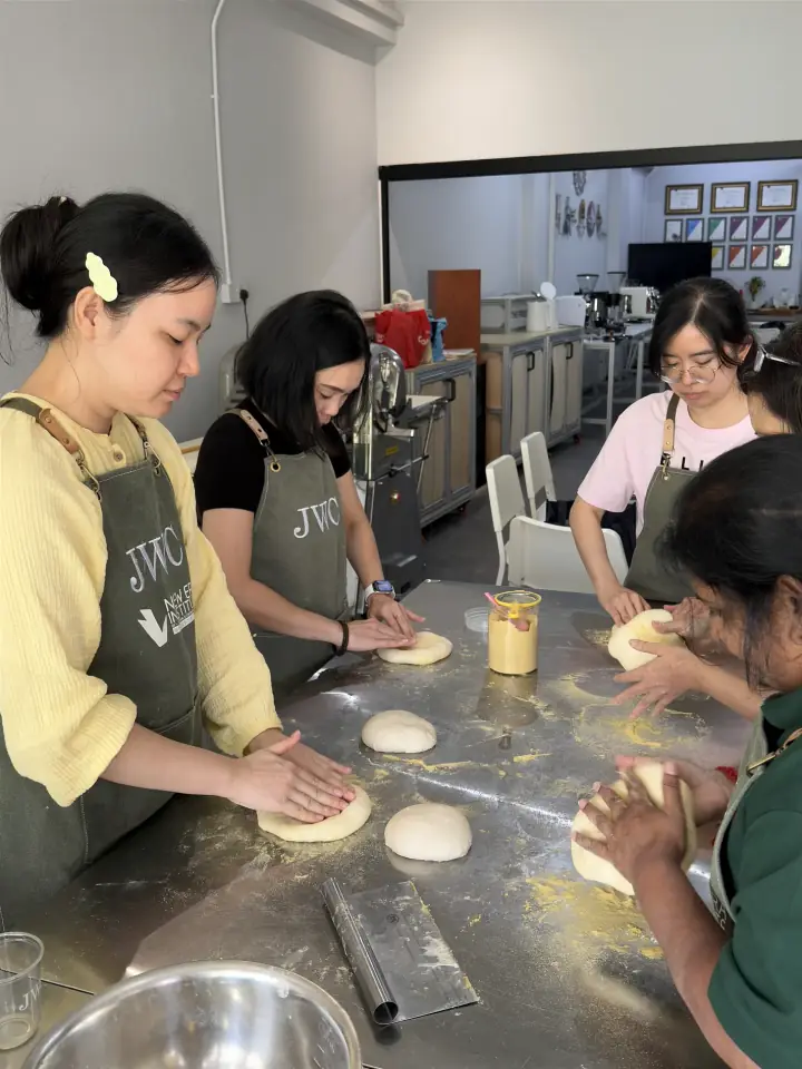 Students kneading dough during weekend baking class