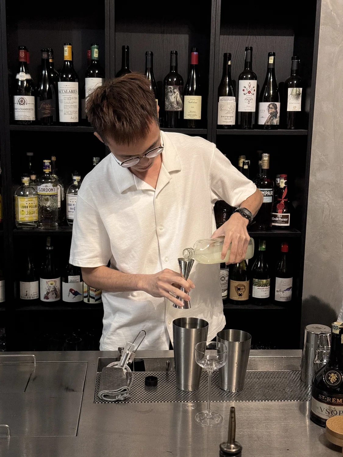 JWC Academy bartending student measuring ingredients at the training bar