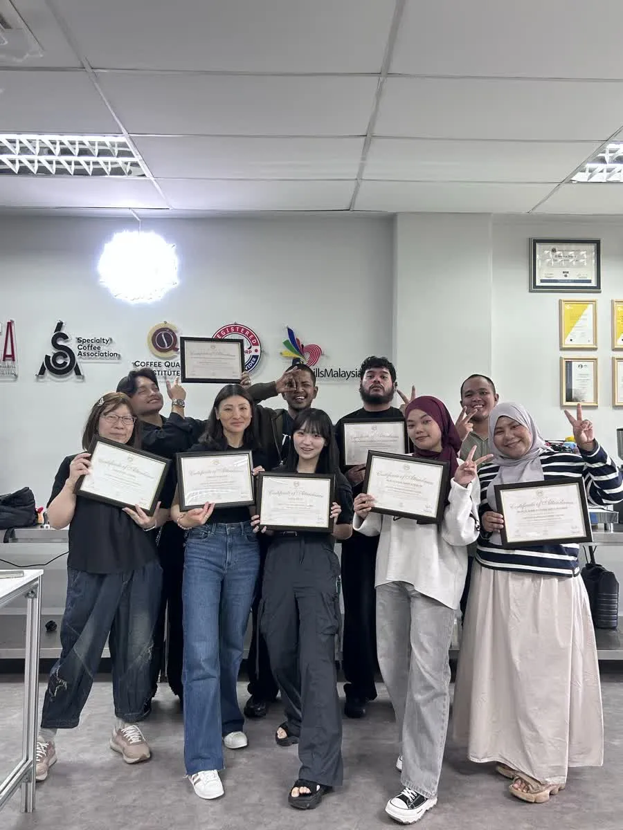 JWC Academy coffee students holding their attendance certificates after graduation