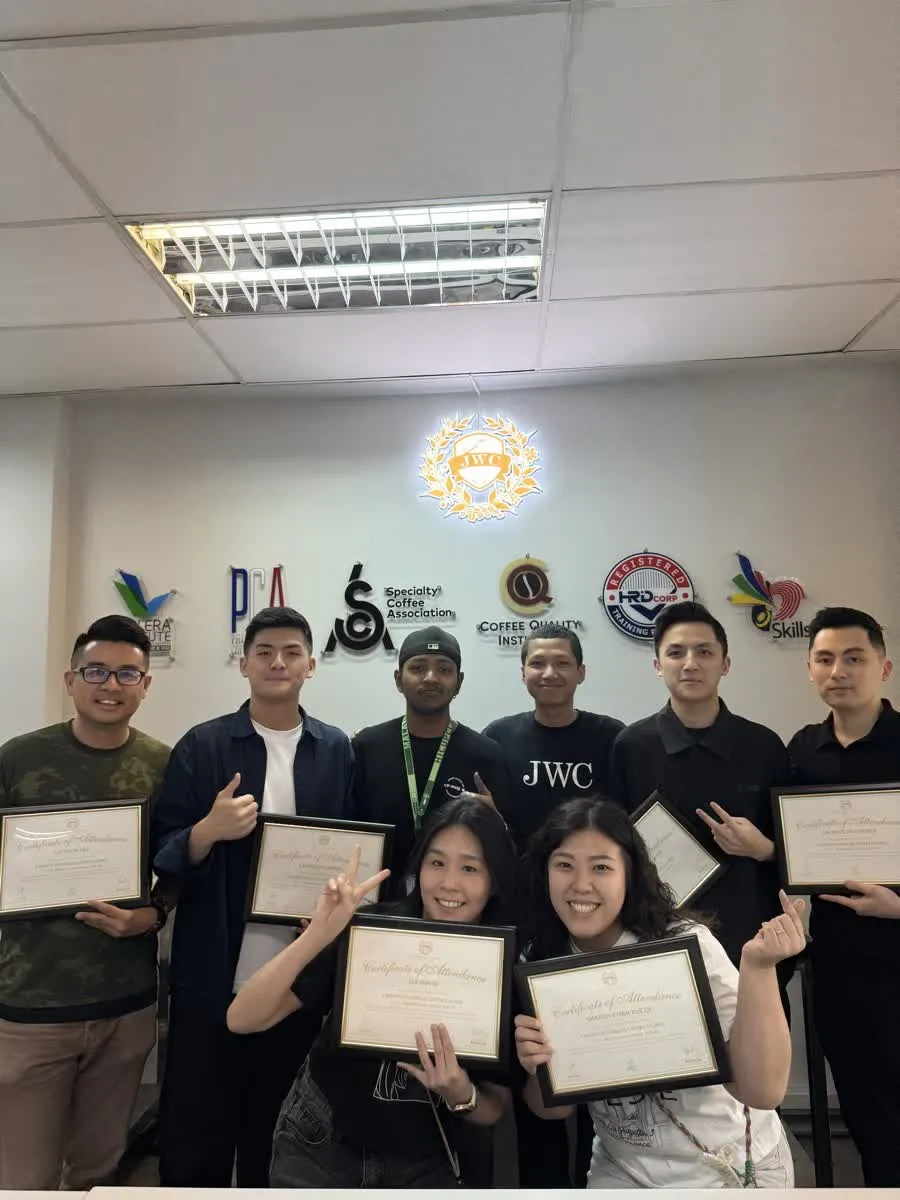 Coffee students and instructors at a JWC Academy graduation moment