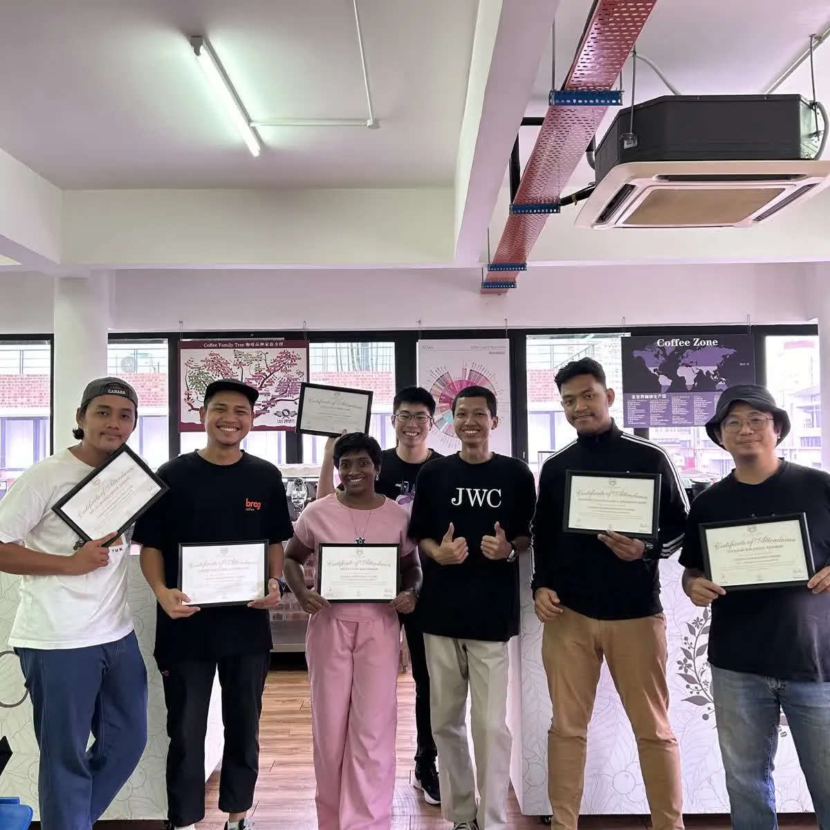 Another JWC Academy coffee course cohort holding completion certificates