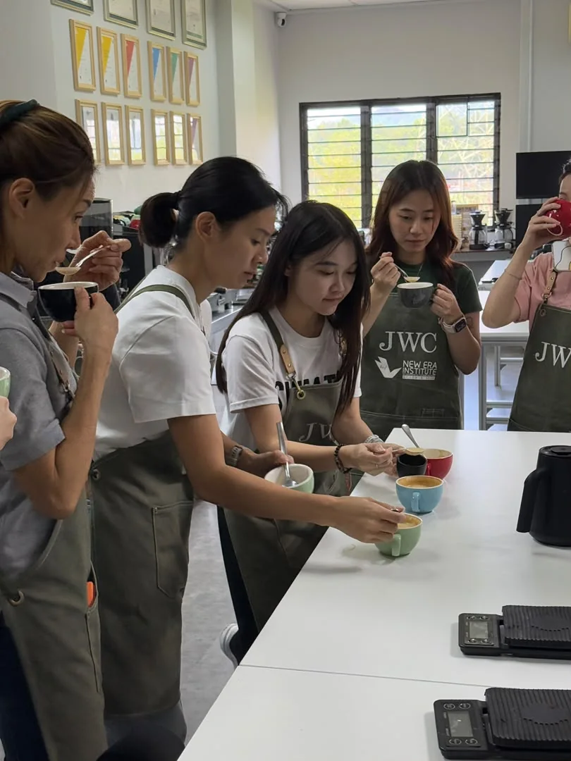 JWC Academy student tasting coffee to identify and correct flavour
